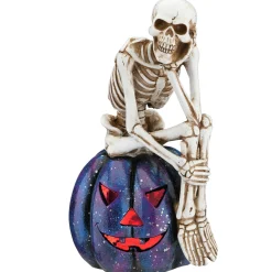 11 in. Halloween Skeleton Resting on a Purple Galaxy Jack O Lantern Indoor Decorations